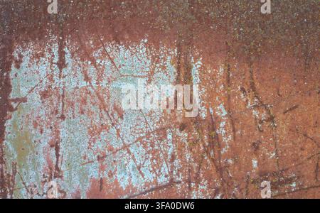 Rusty iron sheet texture. Weathered and oxidized steel sheet with peeling paint traces. Industrial decay, aging, and grunge background. Stock Photo