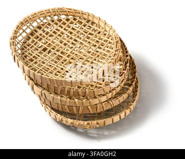 stacked woven bamboo string hopper trays isolated white background, traditional handmade rattan kitchen utensils with grid pattern Stock Photo