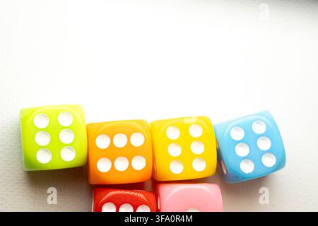 Close up shot of multi colored dice displaying six pips each Stock Photo