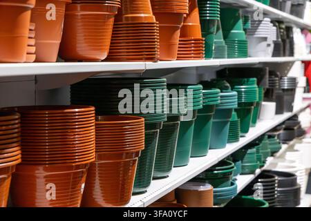 A retail display showcasing a variety of plastic containers for gardening and plant cultivation Stock Photo