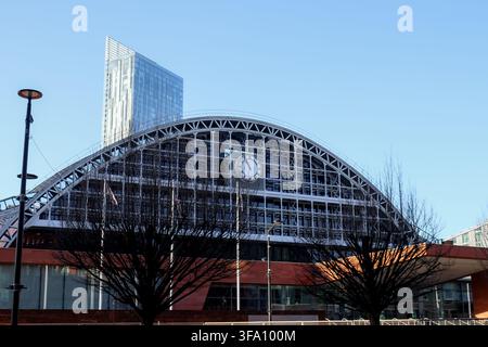 Exterior view of Manchester Central Convention Complex in Manchester, United Kingdom, featuring its sweeping iron and glass roof, large central clock, Stock Photo