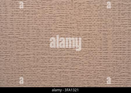 Close-up of beige textured paper with a subtle woven surface pattern, creating a warm abstract background suitable for wallpaper, packaging, stationer Stock Photo