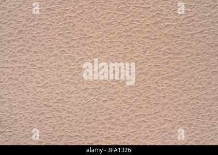 Subtle beige paper texture with an irregular embossed surface creates a warm abstract background for neutral wallpaper, stationery, packaging, web des Stock Photo