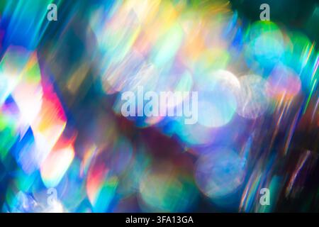 Vibrant abstract background of multicolored bokeh light, soft lens blur, and prism refraction. Glowing circles and rainbow streaks create a dreamy lum Stock Photo