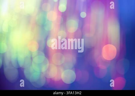 Dreamy abstract background with multicolored bokeh circles, soft glow, and blurred light textures in purple, blue, pink, green, and yellow tones. Stock Photo