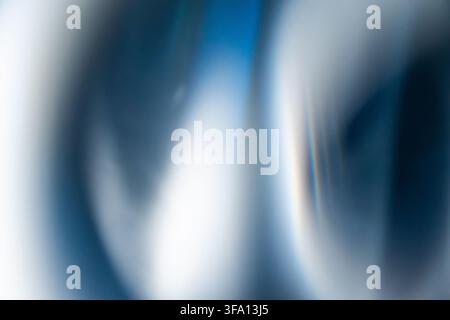 Soft abstract composition of blue, white, and dark navy blurred light streaks, creating a modern atmospheric background with a smooth, luminous and mi Stock Photo