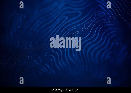 Dark blue abstract background with glowing topographic contour lines forming an organic flowing pattern, ideal for technology, data visualization, map Stock Photo