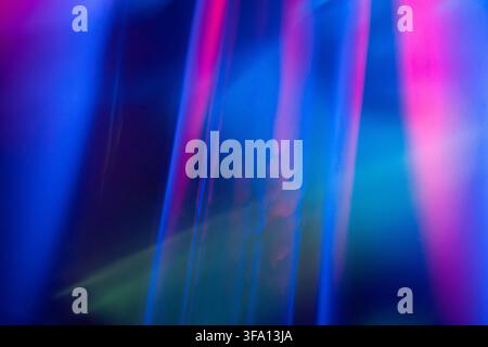 Abstract blue and magenta neon light streaks create a soft blurred motion background with luminous gradients, ideal for futuristic technology, nightli Stock Photo