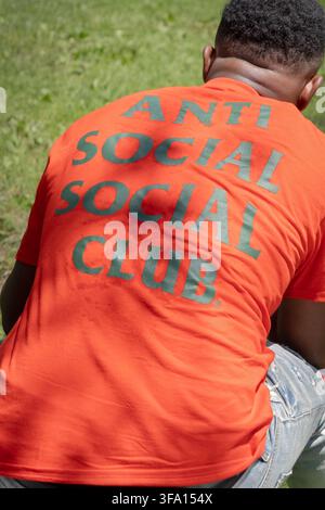 A  man wearing an anti Social Social Club tee shirt outdoors at the 2026 Hudson Valley Caribbean Festival in Poughkeepsie, New York. Stock Photo