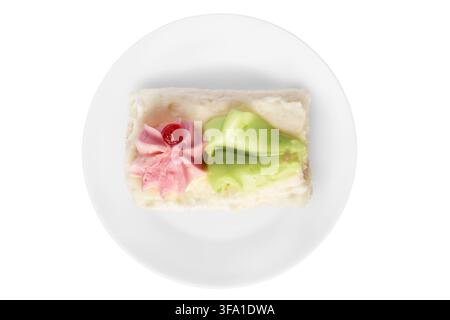 Biscuit cream cake on white ceramic dish isolated on white background Stock Photo