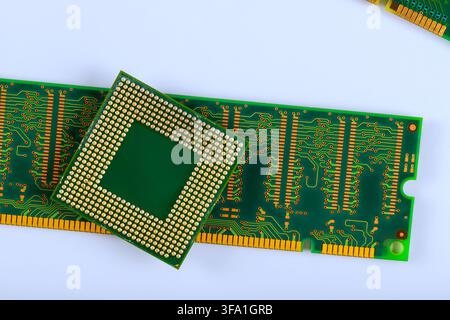Microprocessor is placed on green RAM circuit board electronic components on work surface. Stock Photo