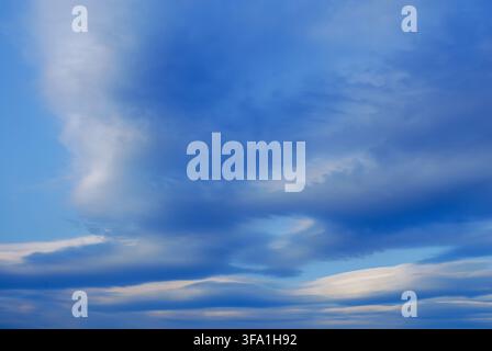 Scenic view of a vibrant blue sky filled with unique altocumulus lenticularis and stratified cloud formations creating a dramatic and textured atmosph Stock Photo