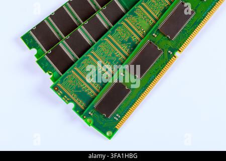 Memory chips are placed in rows on green circuit board surfaces with intricate electronic patterns, Stock Photo