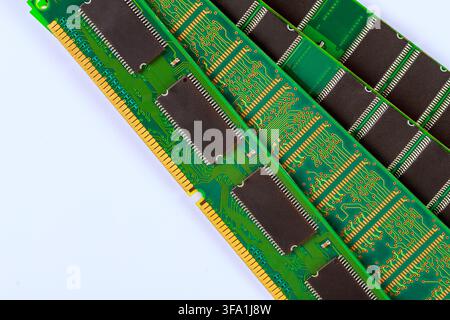 Several computer memory sticks lie on white surface green circuits dark chips arranged in rows. Stock Photo