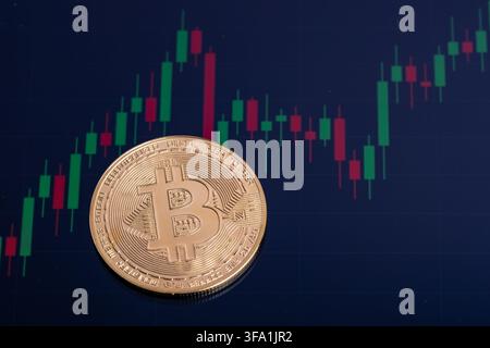 Bitcoin coin shows details on a background of stock market data Stock Photo