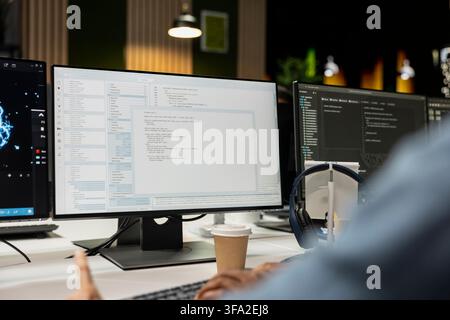 Close up of system administrator coding on PC in startup office, refining machine learning models to enhance automation. IT worker using coding platform on computer in technology company workplace Stock Photo