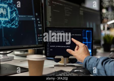 Close up of programmer using tablet in office, reviewing AI system metrics, monitoring performance dashboards. Technology company worker tuning neural networks using tools on device Stock Photo