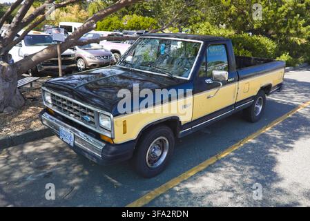 Classic two-tone vintage first generation Ford Ranger pickup truck parked under tree shade in Comox on Vancouver Island, British Columbia. Stock Photo