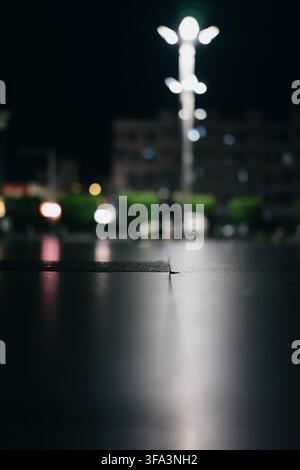 Nighttime urban street in Istanbul, Turkey — wet pavement reflects glowing streetlight and blurred Stock Photo