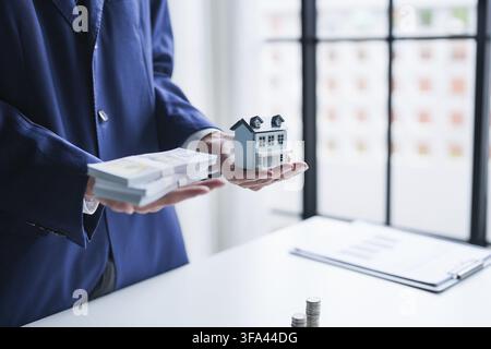 Real Estate Broker Offering Home Insurance and Property Security Consultation While Presenting House for Buying Process Stock Photo