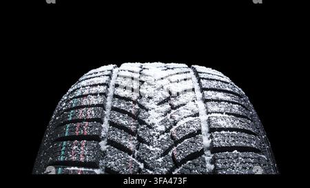 Winter Car tires with snow close-up wheel profile structure on black background Stock Photo