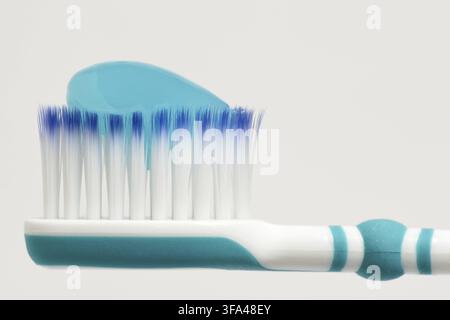 Toothbrush head with blue toothpaste on Stock Photo