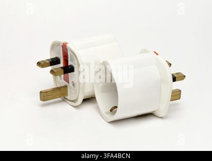 European to UK plug adapters for converting EU plugs to British sockets as essential travel accessories for visitors to the United Kingdom. Europlug t Stock Photo