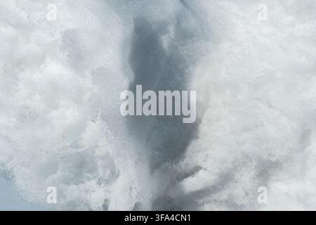 a Light and shadow, a pattern on the surface of the snow. Play of light, a beautiful winter background. Stock Photo