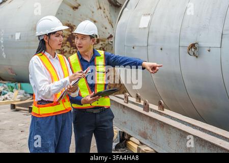 Engineer team discussing project details at industrial site for improved management. Ideal for business, project management, engineering, teamwork, an Stock Photo