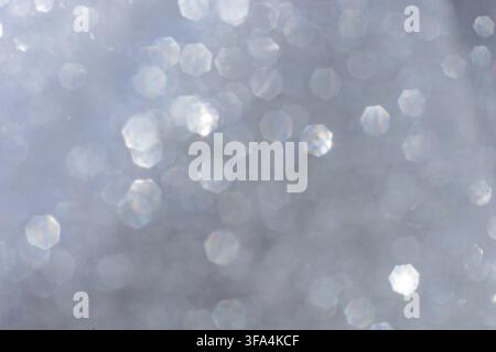 Abstract glitter lights textured silver, gray and white colored background, de-focused, bokeh. Christmas or New Year festive blured sparkling backgrou Stock Photo