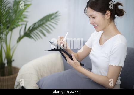 Woman hand presses on screen digital tablet Online Digital marketing technology concept Stock Photo