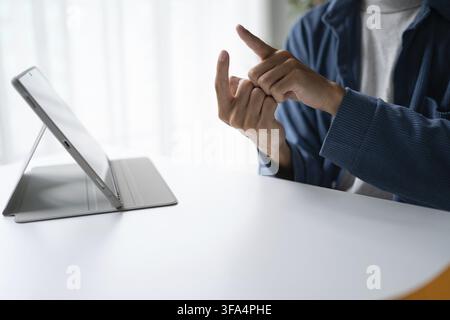 Close up of man using sign language for ASL for accessible online learning and virtual communication Stock Photo