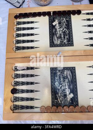 Board for a game of backgammon on a wooden table . Blocks on a wooden background . Cropped image of backgammon playing on a wooden board over the whit Stock Photo