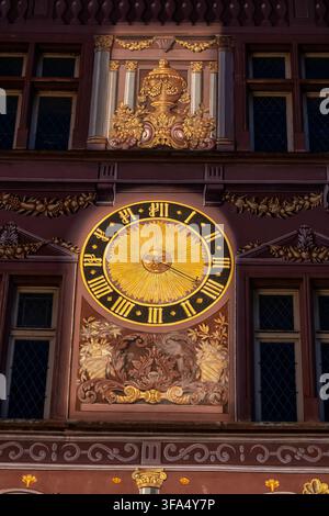 Clock with Roman numerals and sun on a wall of the City Hall (Hotel de Ville), housing History Museum in Mulhouse, Alsace, France. Stock Photo
