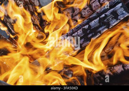 Crest of flame on burning wood in fireplace Stock Photo
