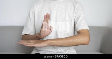 Close up of deaf man using sign language for ASL communication and learning concept Stock Photo