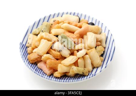 Traditional Japanese small rice crackers in a dish isolated on white background Stock Photo