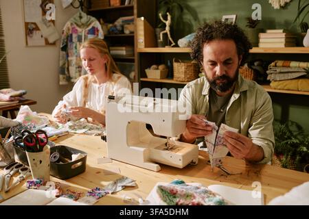 Man and Woman Working in Creative Sewing Workshop Stock Photo