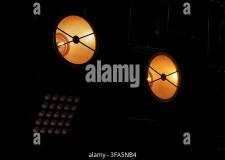 spot light projector lamps back stage equipment in the dark black background copy space pattern Stock Photo