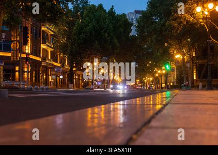 Low angle view of illuminated city street and classic architecture at night in Tianjin Stock Photo