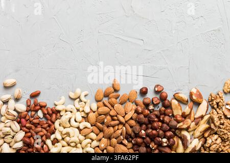 different nuts frame background. Close up, top view, flat lay with vopy space. Walnut, pistachios, almonds, hazelnuts and cashews. Stock Photo