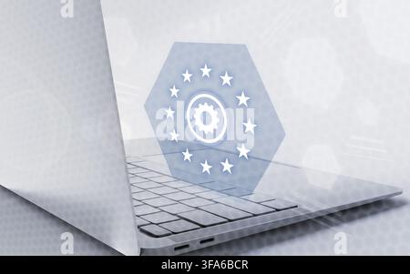 A modern laptop keyboard with a digital hexagon icon featuring EU stars and a central gear representing European technology regulation and governance. Stock Photo