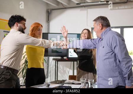 Business team engages in collaborative brainstorming and strategy session in a bright office space during the afternoon Stock Photo