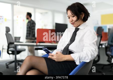 Business professionals engaging in work and communication in a modern office setting with a focus on collaboration and productivity during the day Stock Photo