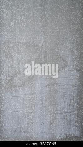 Vertical close-up view of a galvanized steel sheet metal surface that is smooth and flat with water marks, scratches, and a weathered appearance Stock Photo