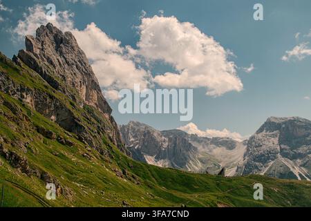 Seceda mountain peak in the Dolomites, South Tyrol, Italy, with dramatic limestone cliffs and green alpine slopes under a cloudy summer sky. Stock Photo