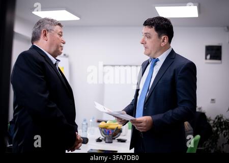 Professional discussion between two business colleagues in a modern corporate office setting Stock Photo