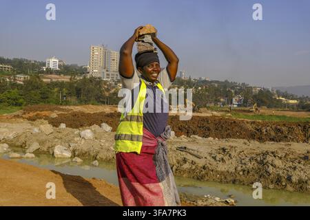 Worker carrying blocks on construction site in Kigali, Rwanda. Stock Photo