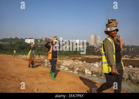 Worker carrying blocks on construction site in Kigali, Rwanda. Stock Photo