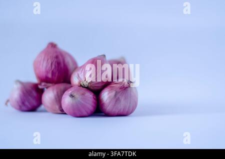 Pile of Shallots on Light Blue Background Stock Photo